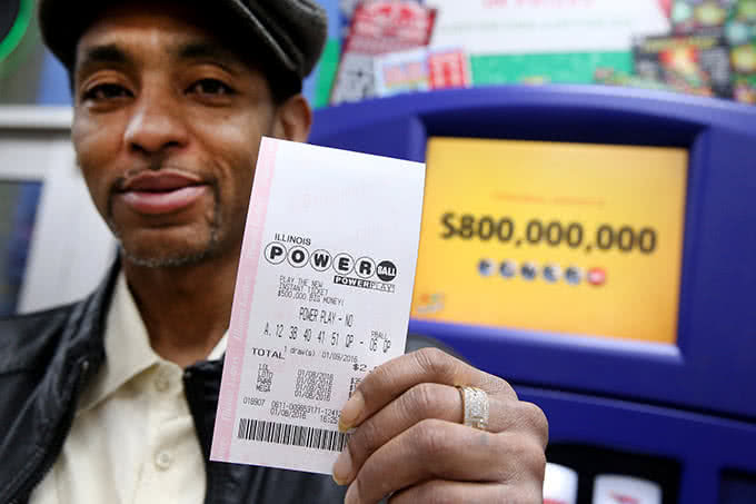 A man with Powerball lottery ticket in his hands